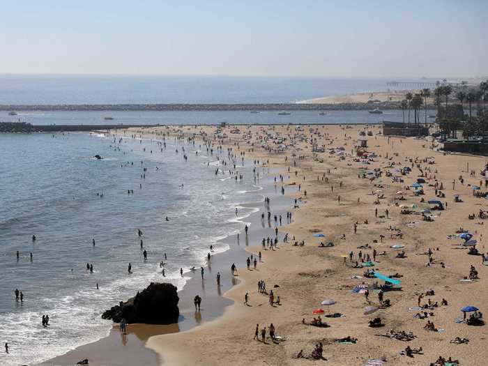 In Orange County, where many beaches remain open, Newport Beach saw an estimated 40,000 visitors Friday. Similar crowds were expected Saturday. Some residents compared it to Fourth of July crowds.