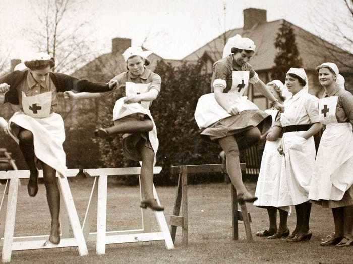 In their spare time, Red Cross nurses exercised by jumping hurdles.