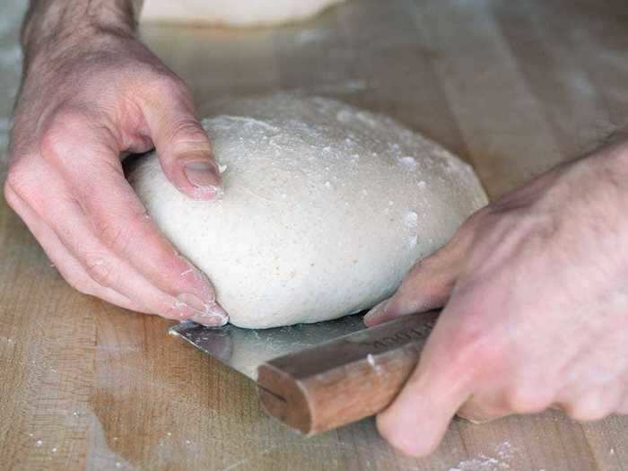 A bench scraper for shaping and cutting dough