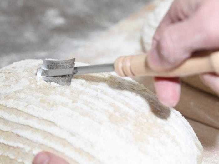 A scoring knife that easily cuts the top of the loaf