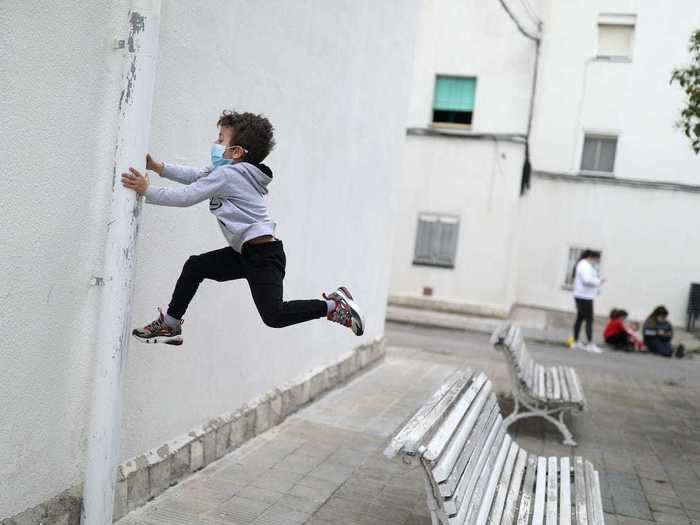 Most of the children still wear face masks as they play in the streets.