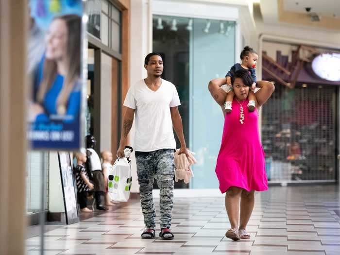 Ben and Shae Owens, right, shop at Columbia Place Mall with their one-year old daughter, London Owens, on April 24, 2020 in Columbia, South Carolina. Beaches and some businesses deemed nonessential were allowed to reopen this week in South Carolina.