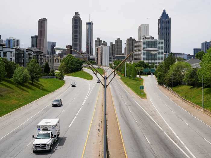 An ambulance is seen in the foreground of the Atlanta skyline days before the phased reopening of businesses and restaurants from coronavirus disease (COVID-19) restrictions in Atlanta, Georgia.