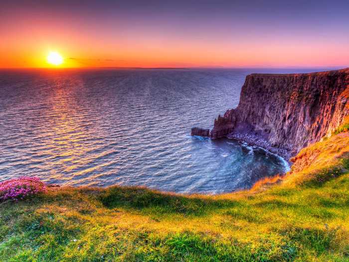 Relax during golden hour by viewing the sunset off the Cliffs of Moher in Ireland.