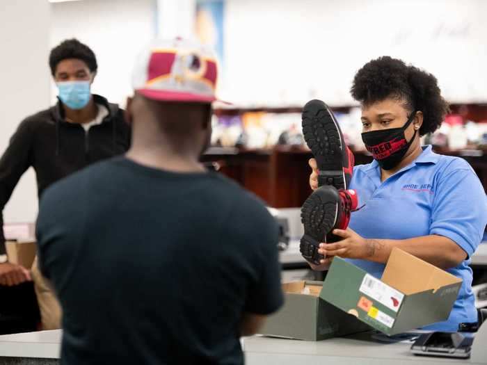 Meanwhile, many mall employees wore masks as they assisted customers ...