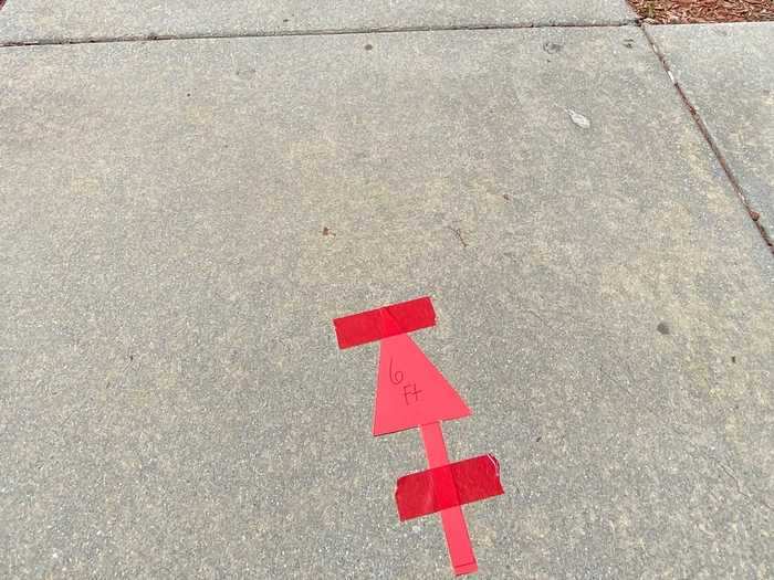 Outside the restaurant, customers will be required to wait in line six feet apart. Six-foot distances are market in red tape on the concrete.