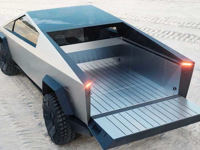 The Cybertruck is made of stainless steel. Tesla calls the bed a "vault." It has a retractable cover and built-in slots to enable customization.