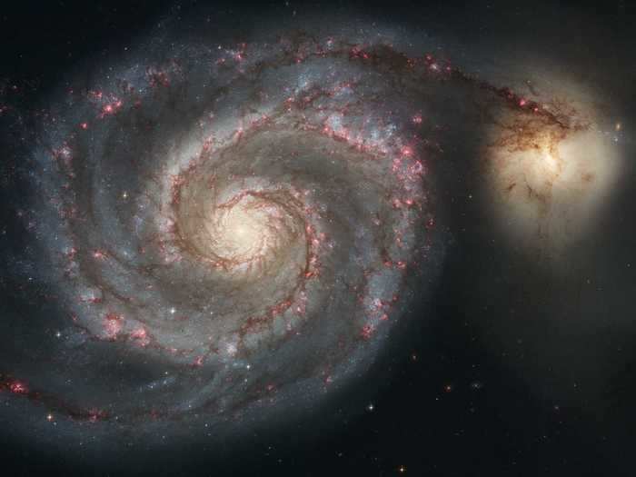 The picturesque Whirlpool Galaxy has been gliding past the smaller galaxy on the left for hundreds of millions of years.