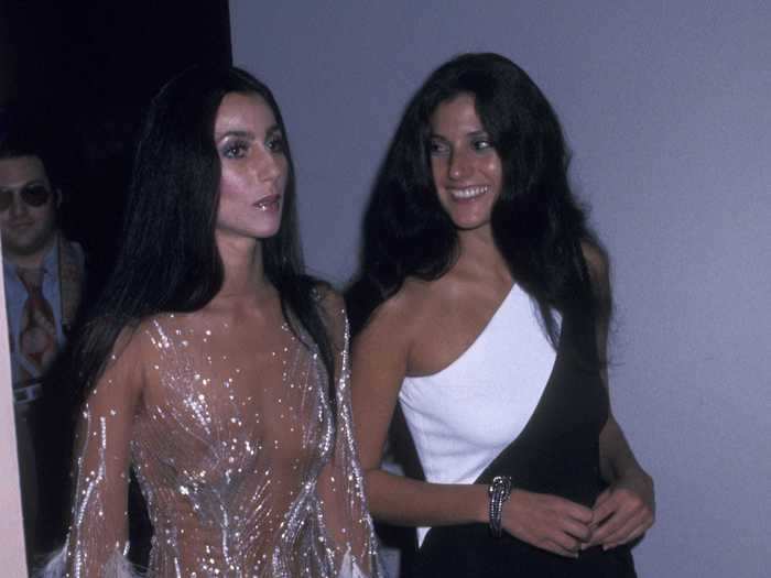 In 1974, Cher wore a sparkling sheer dress with feathers on the sleeves.