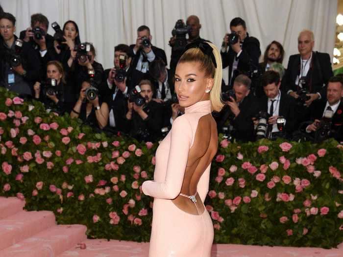 Hailey Bieber walked the Met Gala carpet in a light-pink dress.