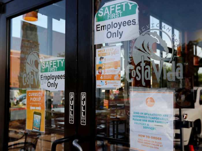 Signs on the front door of Costa Vida explain the current ordering process.