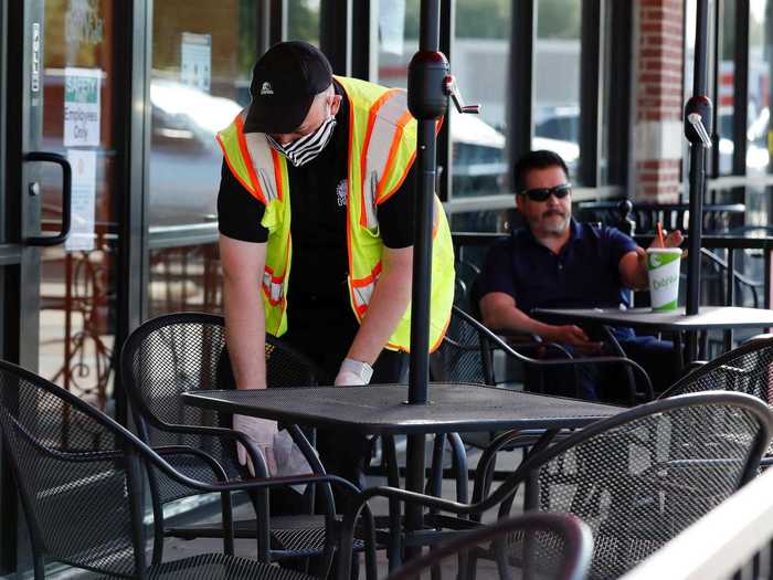 A Costa Vida employee sanitizes the chairs and tables in between parties.