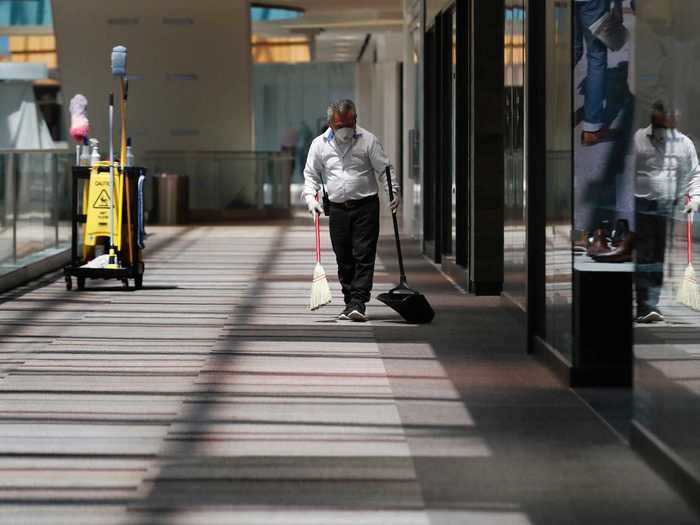 A man sweeps the floors of the Galleria Mall.