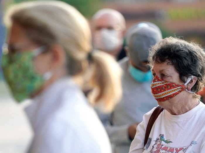 In Houston, masked shoppers wait to enter a store after Harris County Judge Lina Hidalgo mandated on Monday that all residents must wear masks in public with the exception of eating, drinking, or exercising.