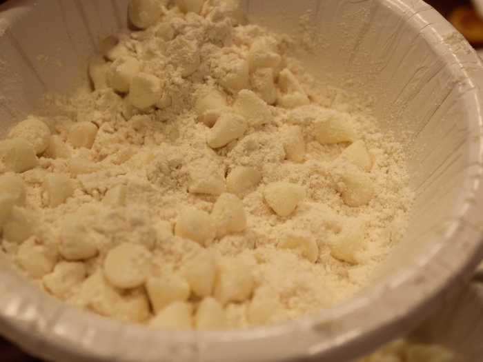 To prevent the white chocolate chips from sinking to the bottom again, we coated them in flour — a trick another one of my sisters picked up from watching Ina Garten on the Food Network.