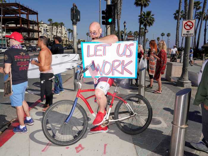 "Let us work," one man had written on his sign.