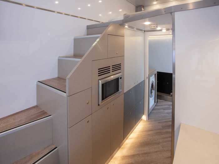 … using a staircase with integrated storage units for smaller belongings.