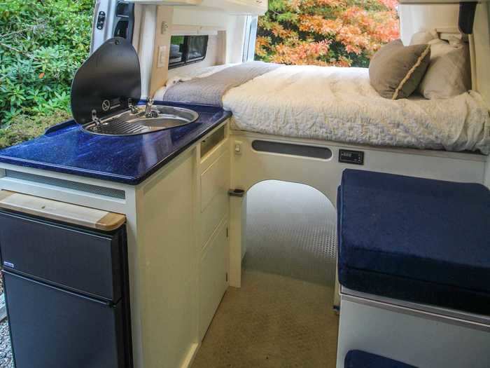 The queen-sized mattress bed is lofted to allow for a garage space underneath …