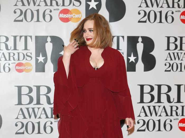 Adele showed up at the 2016 Brit Awards in a custom-made crimson Giambattista Valli gown.