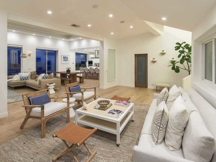 The home includes an open-plan living room, an entertaining area ...