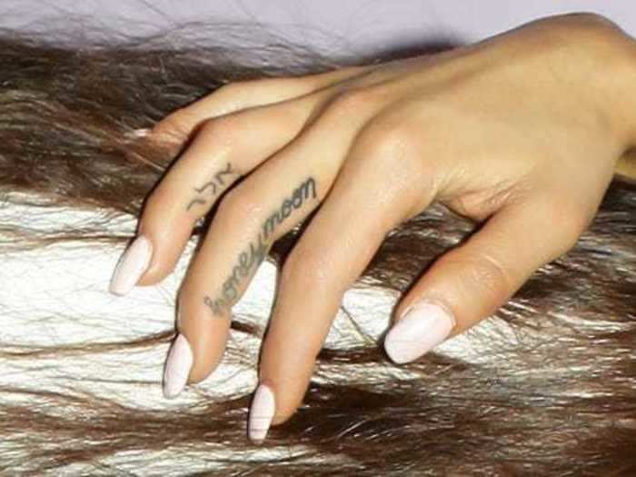  Her right-hand ring finger bears a Hebrew phrase. 