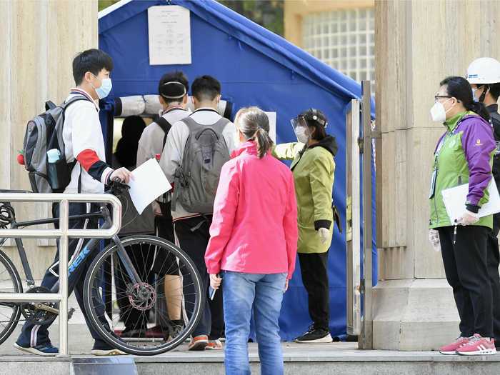 Students undergo temperature checks on arrival