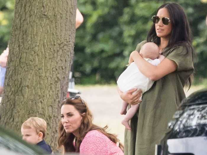 JULY 2019: Here, Markle is pictured cradling the two-month-old alongside Kate Middleton and Prince Louis.