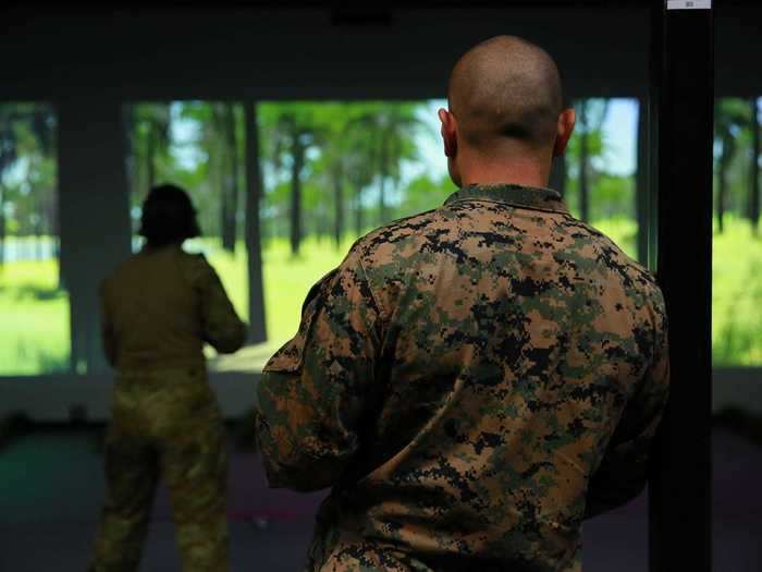 When a loud voice says, "I need two for the drill coming next!" Marines and Australian soldiers step up and load one magazine. "Scenario Begins" appears on the screen. It