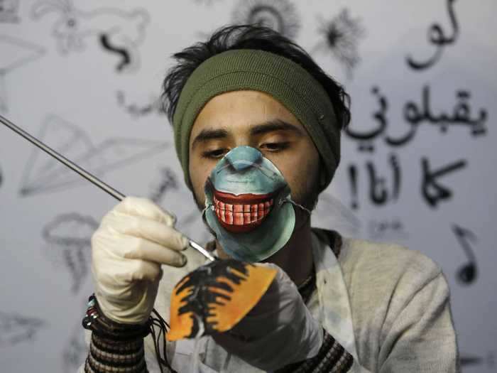 In Gaza City, an artist gives N95 masks a distinct design.