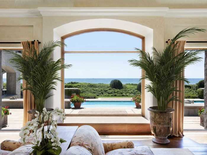 It has four bedrooms, is connected by stone archways, and features ocean views throughout.