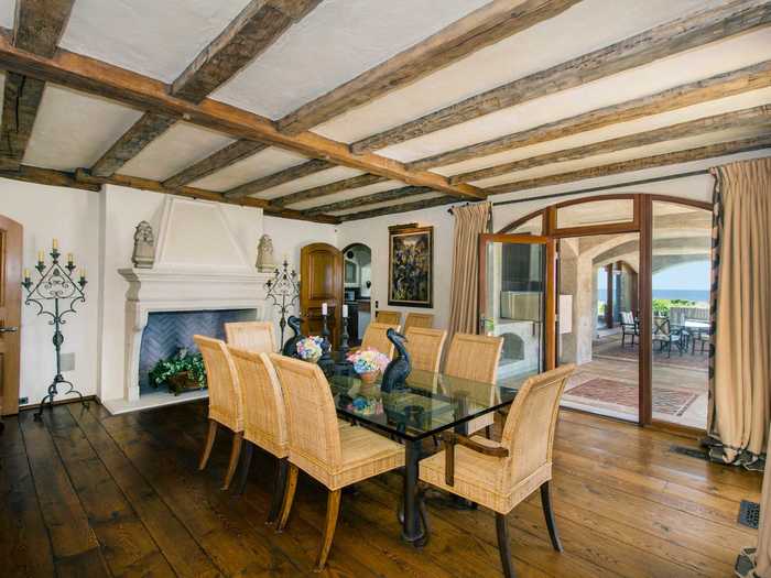 Beams made from exposed wood imported from an actual French chateau line the ceiling of the formal dining room ...