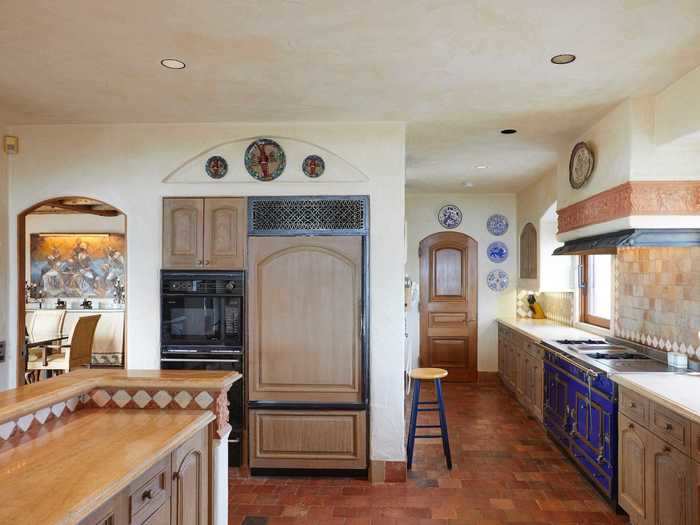 ... and a custom stove and oven by French luxury kitchen supply company La Cornue lend an Old World feel to the kitchen.