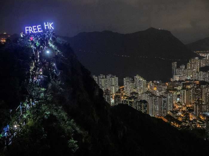 In mid-September, hundreds of protestors formed a human chain and climbed to the peak of Lion Rock, a hill located above the city. They held up signs that read "Free HK" and chanted "Stand with Hong Kong, fight for freedom."