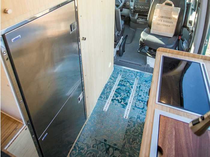 The fridge-freezer sits across the kitchenette.