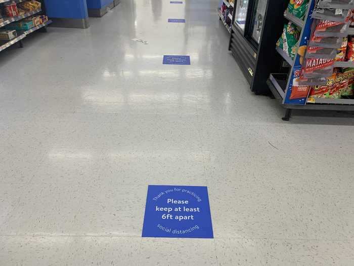 ... and putting decals on the floor indicating where shoppers should stand in line.