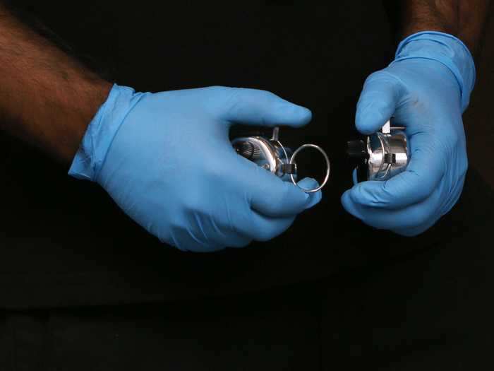 A security staff member keeps a count of customers entering the Apple Store.