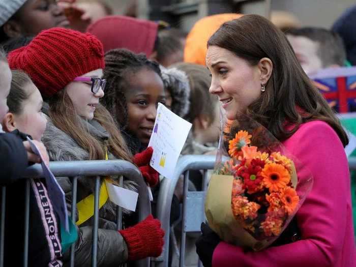 She bends down to meet them at eye level.