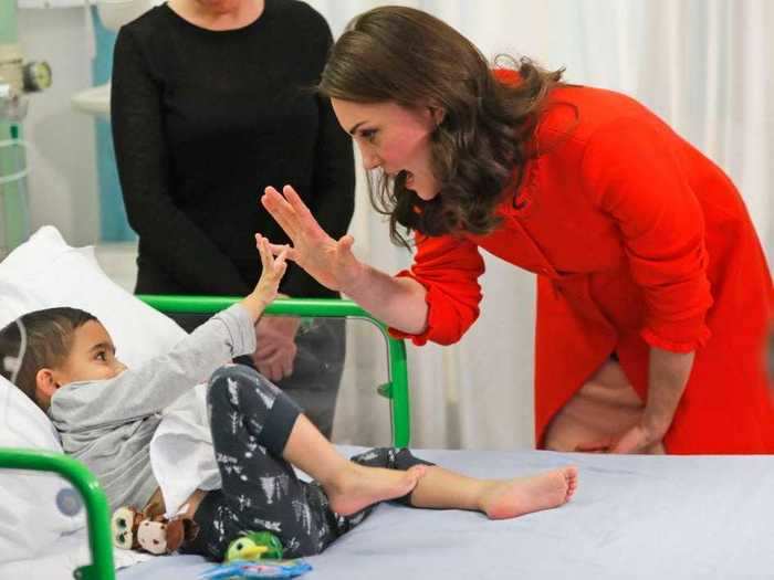 She helps little ones feel better with encouraging high fives.