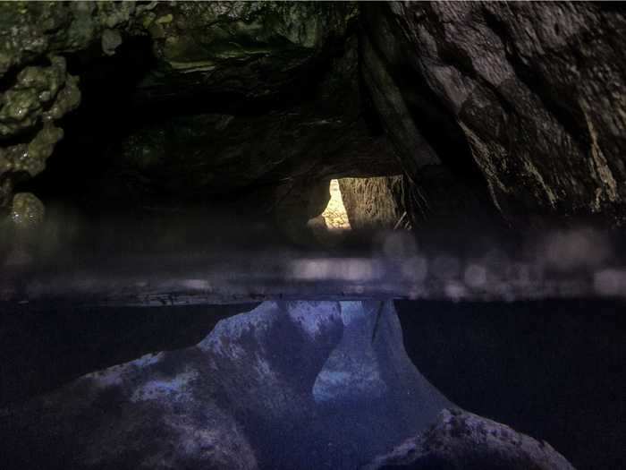 This photo of a cave near the cliff of Cap Canaille in Cassis, southern France, shows the cave from above and below the water