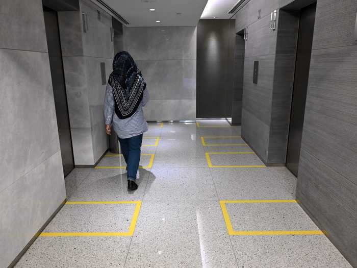 Social distancing in elevator banks: Singapore will remain on lockdown until June 1, but high-rise office buildings there are prepared for social distancing, with yellow tape marking where employees should stand in elevator banks.