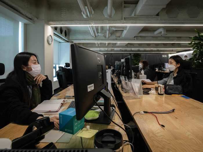 Empty seats between employees: Employees at Hyundai Card practice physical distancing by leaving an empty desk in between each occupied workspace.