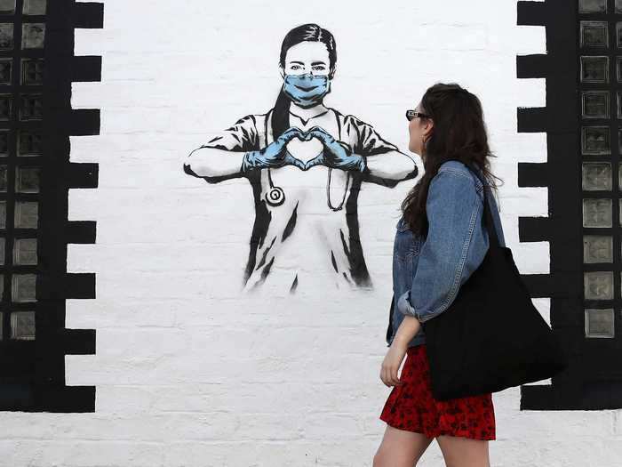 An artist known as the Rebel Bear painted a nurse forming a heart with her hands on Ashton Lane in Glasgow, Scotland.