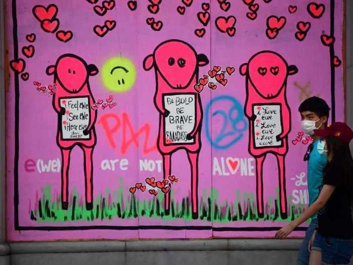 Boarded-up storefronts were redecorated with hopeful messages by artist Love She3P in Los Angeles.