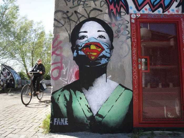 An artist known as FAKE created this "Super Nurse" image in Amsterdam.