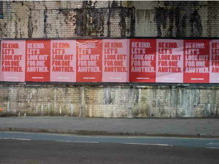 Near the River Thames in London, supportive signs line the walkways.