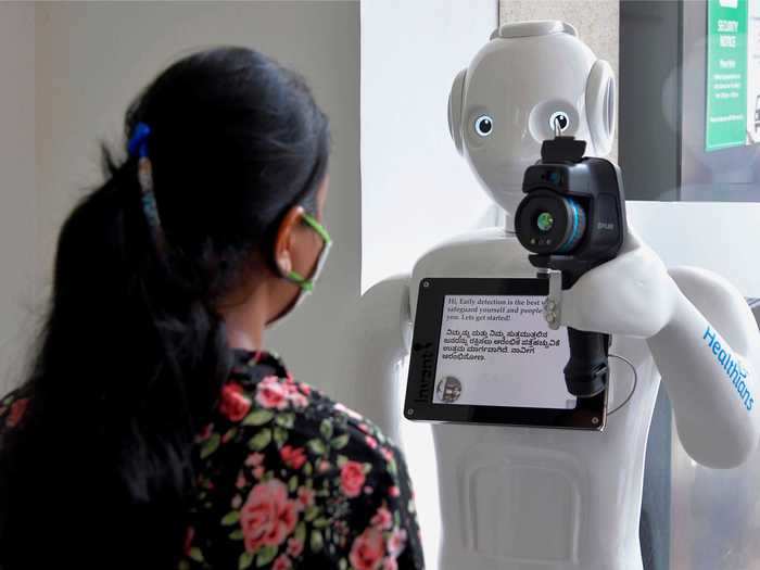 After receiving a temperature reading, the robot gives the patient instructions for their next steps.