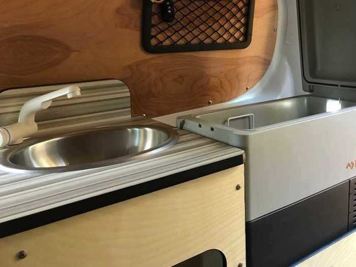 Instead of a grey water tank — which is often found in camper conversions — the sink drains directly out of the van.