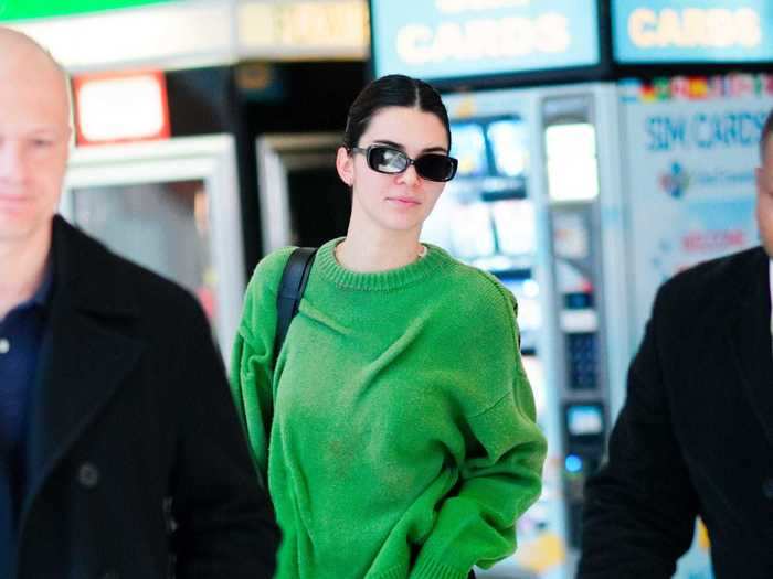 Spotted at John F. Kennedy International Airport in New York, Kendall Jenner wore black sweats and a green sweater.