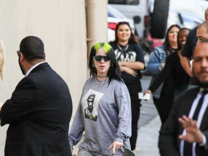 Billie Eilish rolled up one leg of her sweatpants on the street in Los Angeles.