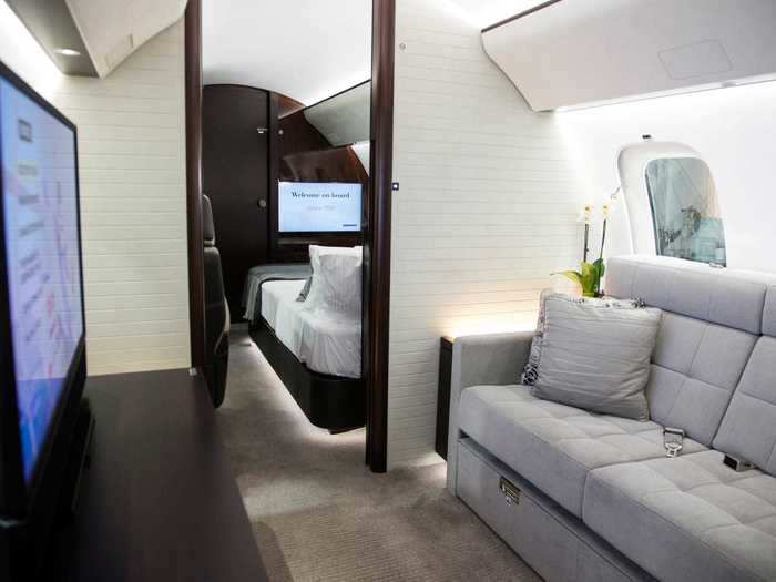 The rear two sections of the aircraft are more private compartments that are closed off from the forward seating areas. The first one behind the conference suite is the entertainment suite featuring a three-person divan and wide-screen high-definition television, resembling a living room.